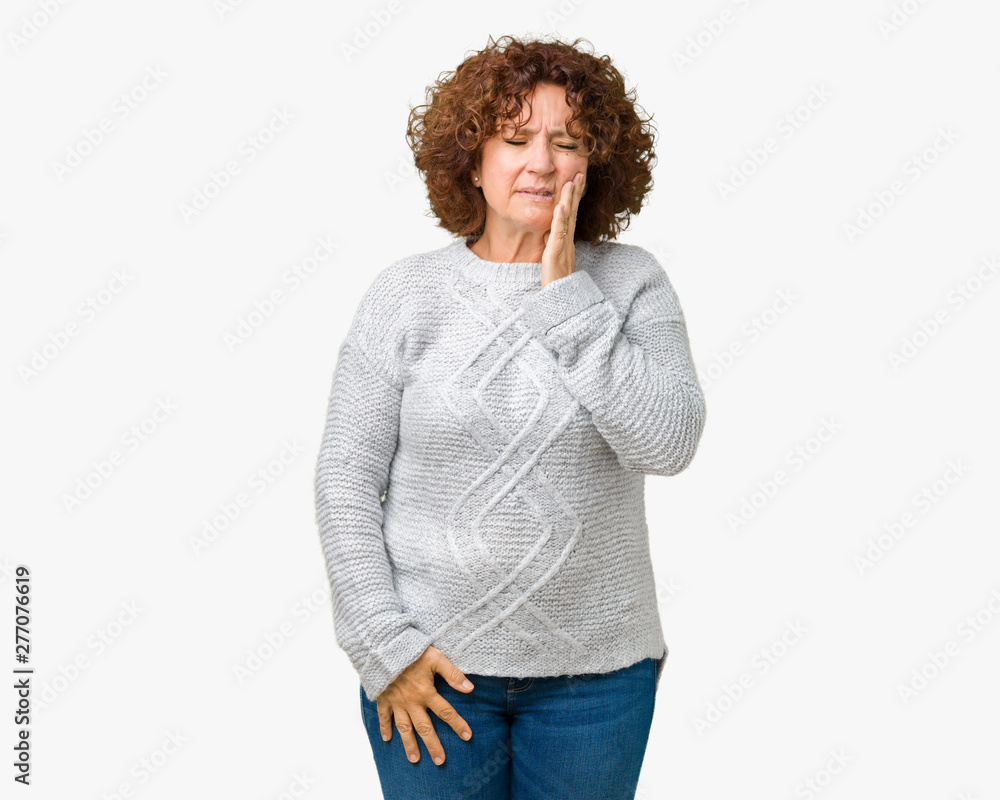 Beautiful middle ager senior woman wearing winter sweater over isolated background touching mouth with hand with painful expression because of toothache or dental illness on teeth. Dentist concept. Beautiful middle ager senior woman wearing winter sweater over isolated background touching mouth with hand with painful expression because of toothache or dental illness on teeth. Dentist concept.