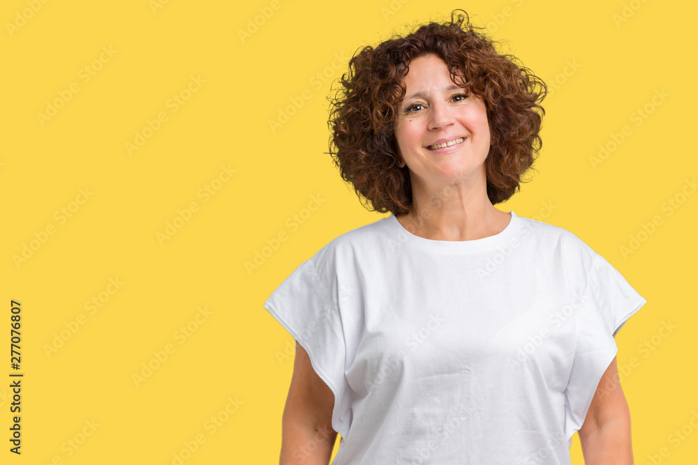 Beautiful middle ager senior woman wearing white t-shirt over isolated background with a happy and cool smile on face. Lucky person. Beautiful middle ager senior woman wearing white t-shirt over isolated background with a happy and cool smile on face. Lucky person.