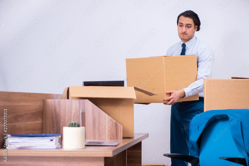 Young handsome businessman being fired from his work Young handsome businessman being fired from his work