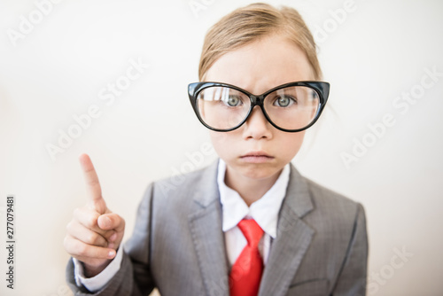 Bilde på lerret Close-up of comic portrait of boss girl with index finger on white background