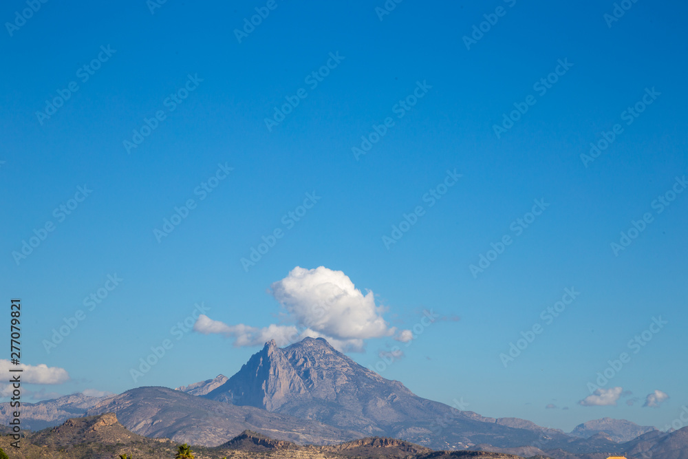 mountain with a cloud on top