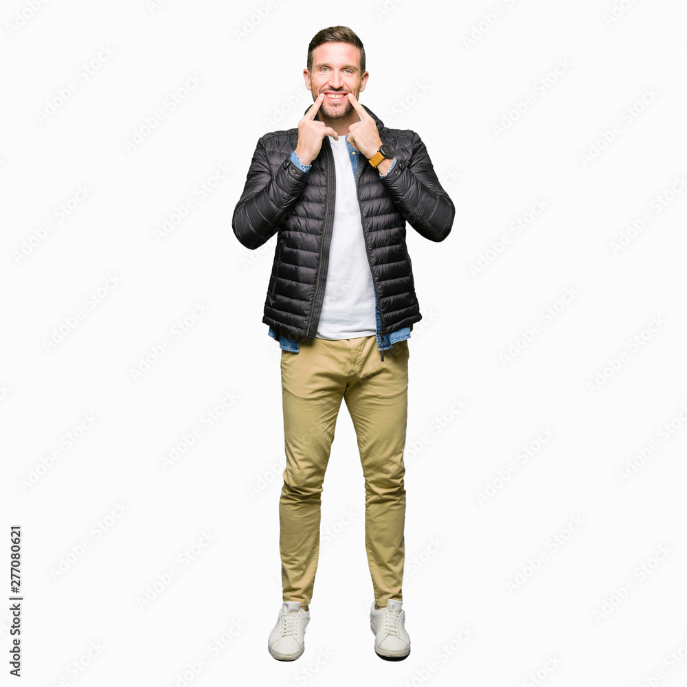 Handsome man wearing winter coat Smiling with open mouth, fingers pointing and forcing cheerful smile Handsome man wearing winter coat Smiling with open mouth, fingers pointing and forcing cheerful smile
