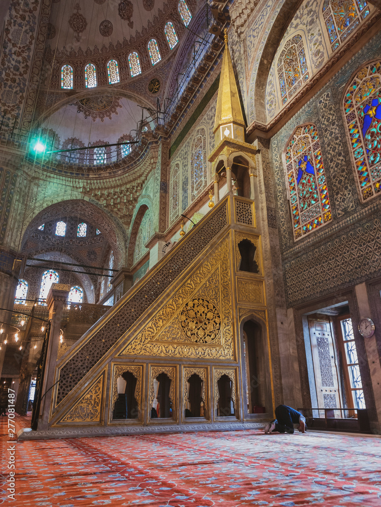 An unidentified man prays inside a mosque.