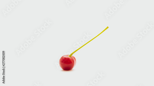 One red cherry with a sprig isolated on a white background © Ra