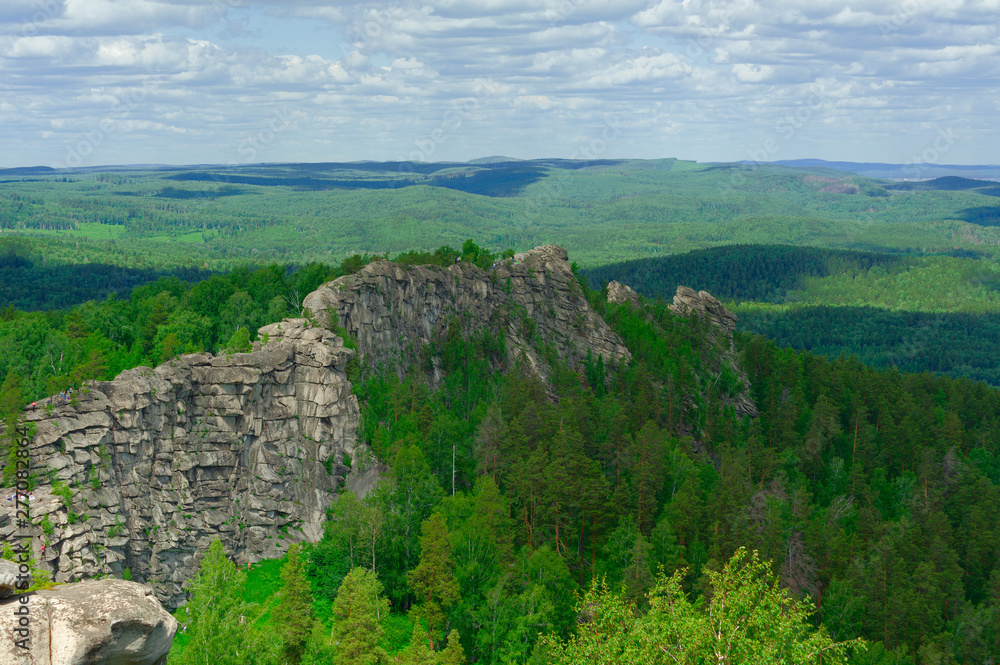 Rocky ridge with people wandering around it