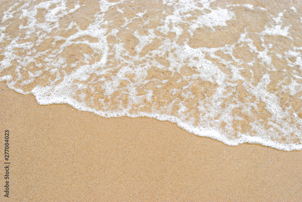 Wave of the sea on the sand beach background and texture Wave of the sea on the sand beach background and texture