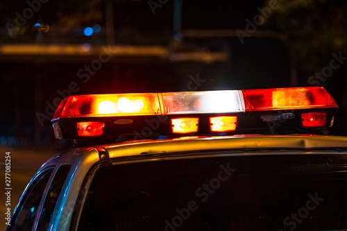 Emergency light, Red light flasher atop of a police car at night © Naypong Studio