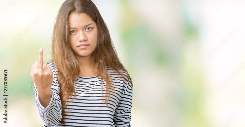 Young beautiful brunette woman wearing stripes sweater over isolated background Showing middle finger, impolite and rude fuck off expression Young beautiful brunette woman wearing stripes sweater over isolated background Showing middle finger, impolite and rude fuck off expression