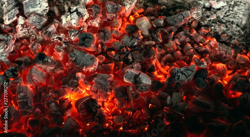 Burning coals from a fire abstract background. photo