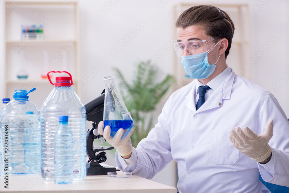 Young male chemist experimenting in lab Young male chemist experimenting in lab