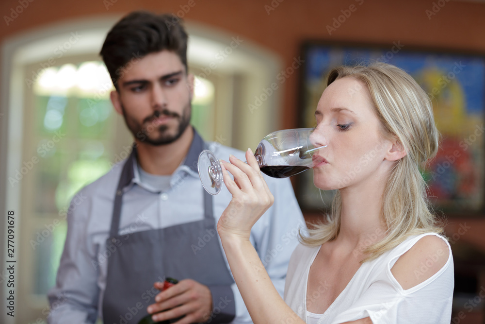a woman tasting free wine a woman tasting free wine