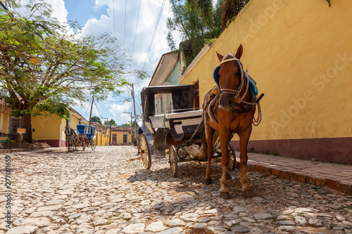 Fototapeta Naklejka Na Ścianę i Meble -  Horse Carriage in the streets of a small Cuban Town during a vibrant sunny day. Taken in Trinidad, Cuba.