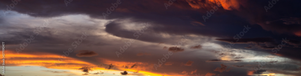 Dramatic Panoramic View of a cloudscape during a dark and colorful sunset. Taken over Beach Ancon in Trinidad, Cuba.