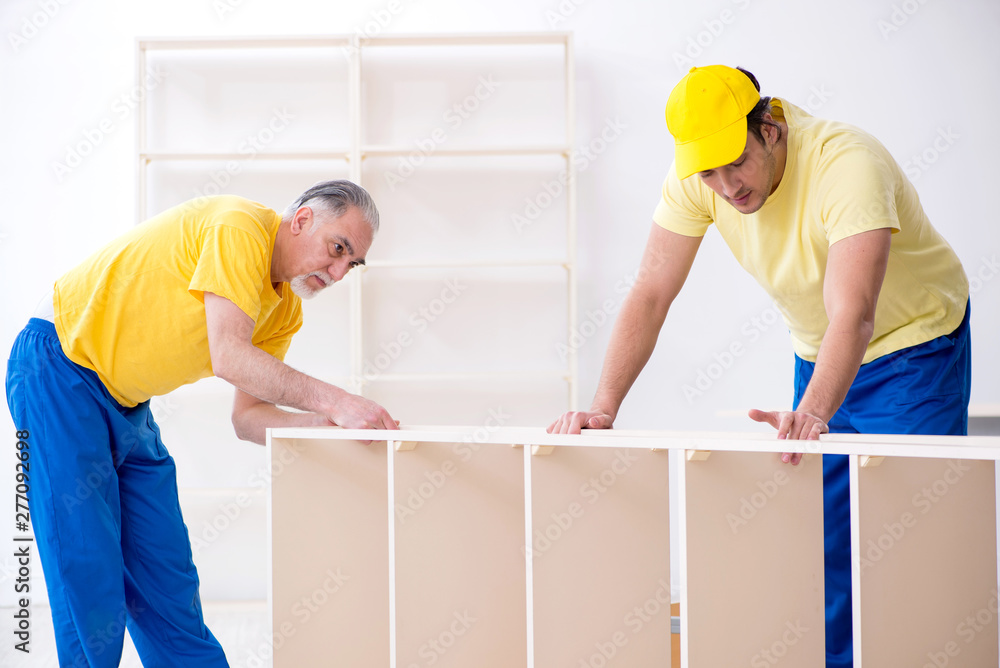 Two contractors carpenters working indoors Two contractors carpenters working indoors