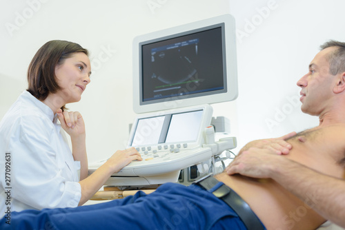young female doctor talking to male patient in clinic