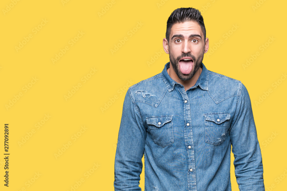 Young handsome man over isolated background sticking tongue out happy with funny expression. Emotion concept. Young handsome man over isolated background sticking tongue out happy with funny expression. Emotion concept.