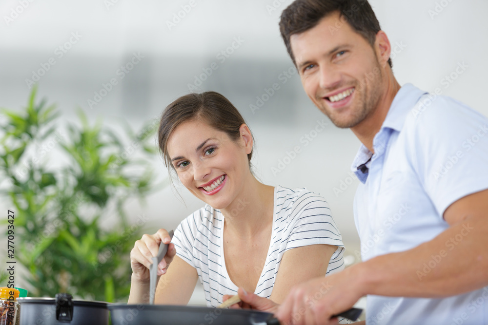 attractive couple is cooking on kitchen attractive couple is cooking on kitchen