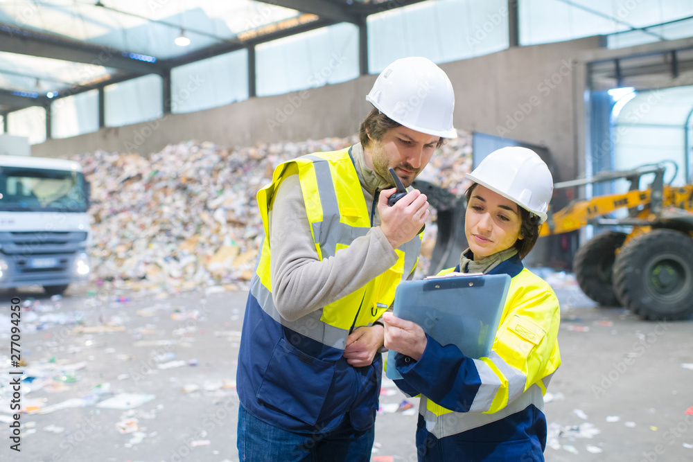 worker using walkie talkie in recycling center worker using walkie talkie in recycling center