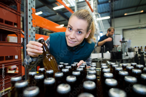 female working with beer bottles