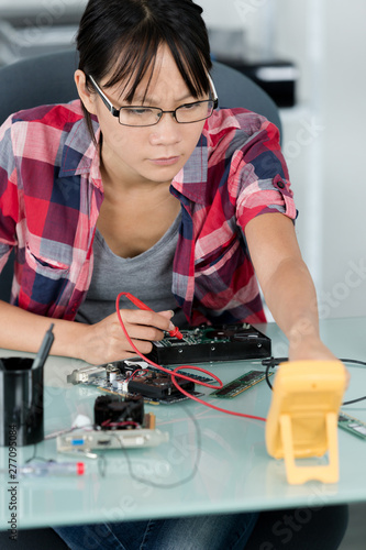 woman fixing power supply from pc