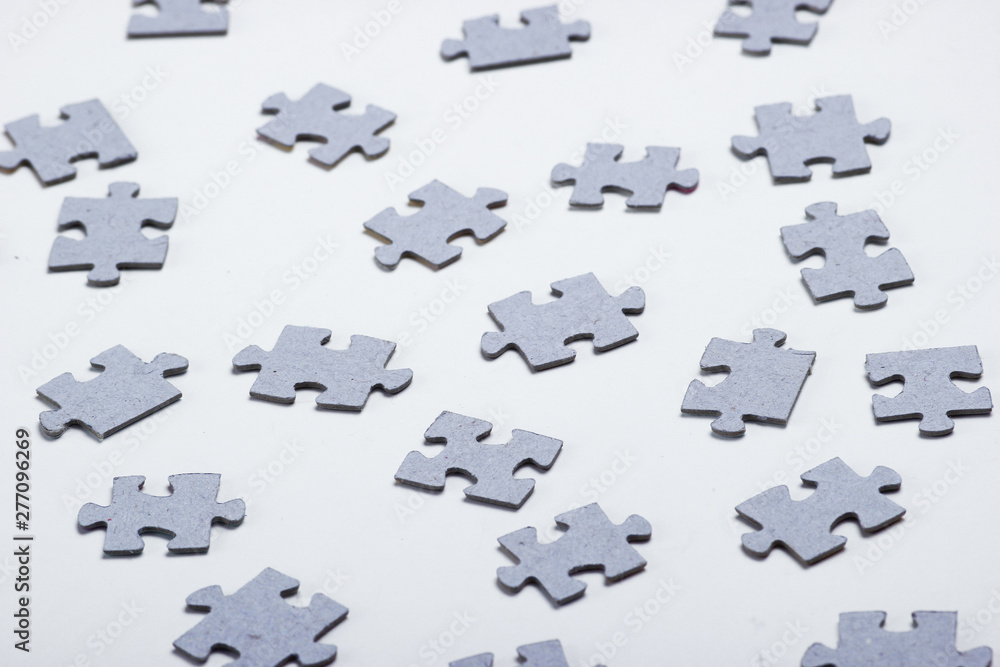 Naklejka premium Many particles of a puzzle on a white background