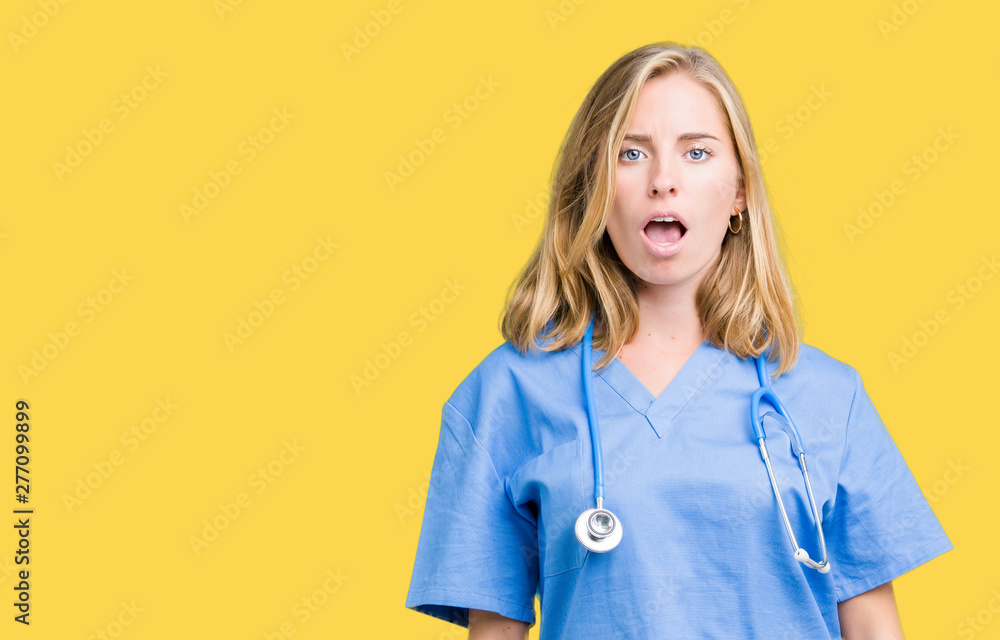 Beautiful young doctor woman wearing medical uniform over isolated background In shock face, looking skeptical and sarcastic, surprised with open mouth Beautiful young doctor woman wearing medical uniform over isolated background In shock face, looking skeptical and sarcastic, surprised with open mouth