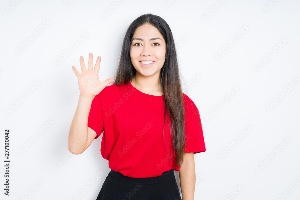 Beautiful brunette woman wearing red t-shirt over isolated background showing and pointing up with fingers number five while smiling confident and happy. Beautiful brunette woman wearing red t-shirt over isolated background showing and pointing up with fingers number five while smiling confident and happy.