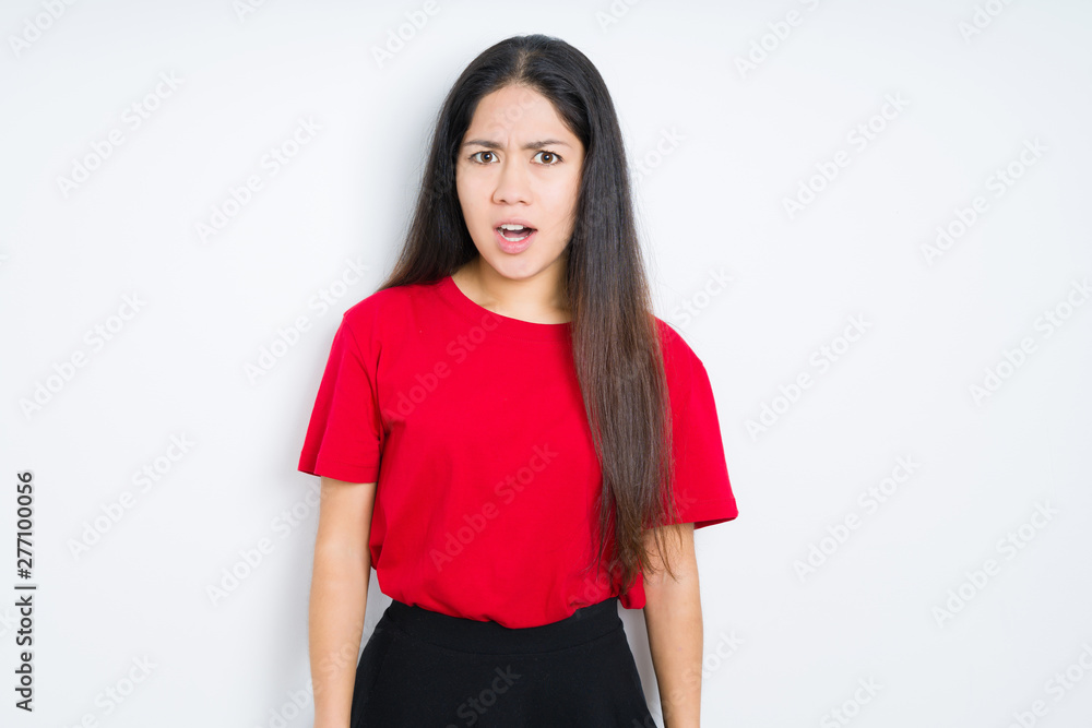 Beautiful brunette woman wearing red t-shirt over isolated background In shock face, looking skeptical and sarcastic, surprised with open mouth Beautiful brunette woman wearing red t-shirt over isolated background In shock face, looking skeptical and sarcastic, surprised with open mouth