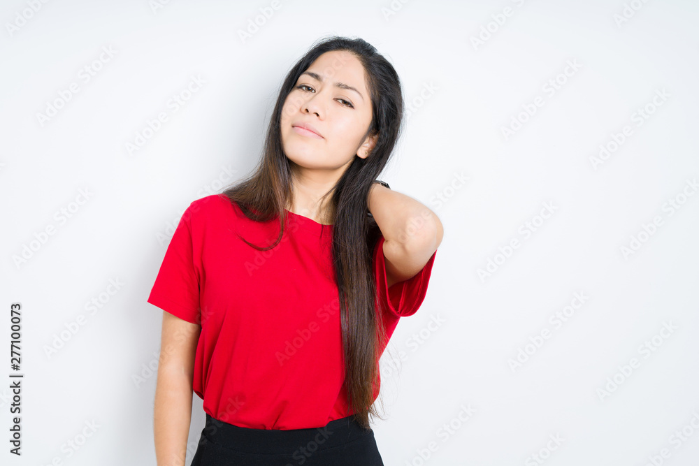 Beautiful brunette woman wearing red t-shirt over isolated background Suffering of neck ache injury, touching neck with hand, muscular pain Beautiful brunette woman wearing red t-shirt over isolated background Suffering of neck ache injury, touching neck with hand, muscular pain