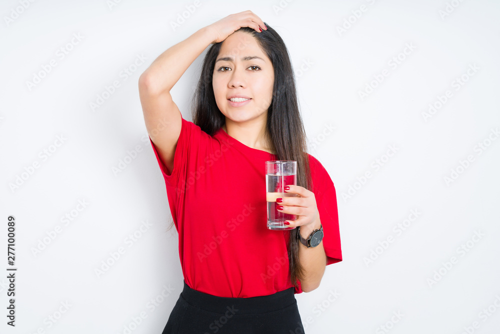 Young brunette woman drinking a glass of water over isolated background stressed with hand on head, shocked with shame and surprise face, angry and frustrated. Fear and upset for mistake. Young brunette woman drinking a glass of water over isolated background stressed with hand on head, shocked with shame and surprise face, angry and frustrated. Fear and upset for mistake.