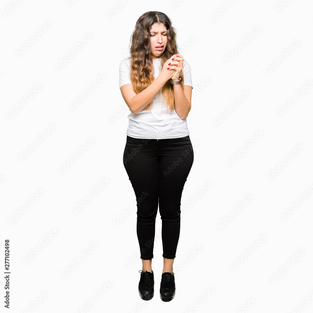 Young beautiful woman wearing casual white t-shirt Suffering pain on hands and fingers, arthritis inflammation