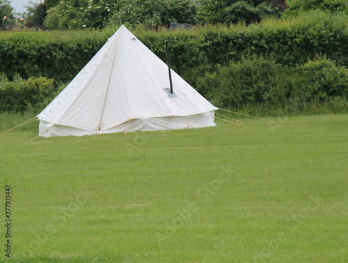 A White Canvas Bell Tent with a Metal Stove Chimney. © daseaford