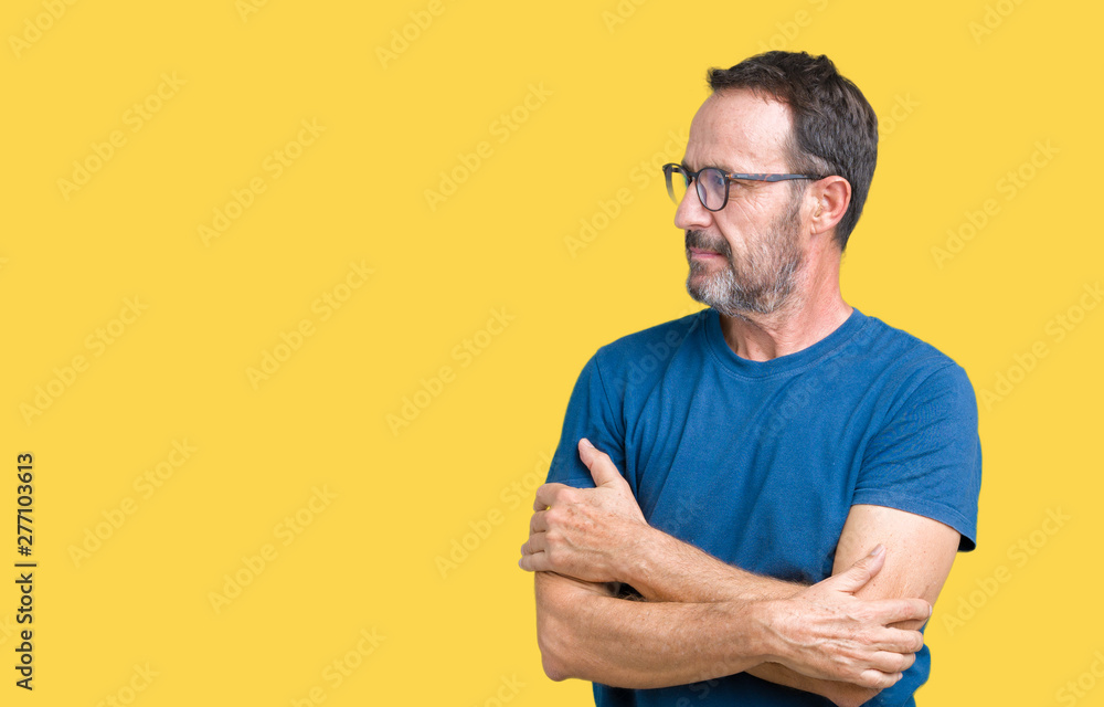 Handsome middle age hoary senior man wearin glasses over isolated background smiling looking to the side with arms crossed convinced and confident Handsome middle age hoary senior man wearin glasses over isolated background smiling looking to the side with arms crossed convinced and confident