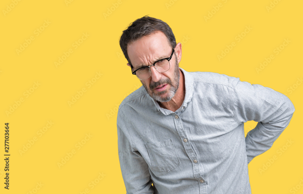 Handsome middle age elegant senior man wearing glasses over isolated background Suffering of backache, touching back with hand, muscular pain Handsome middle age elegant senior man wearing glasses over isolated background Suffering of backache, touching back with hand, muscular pain