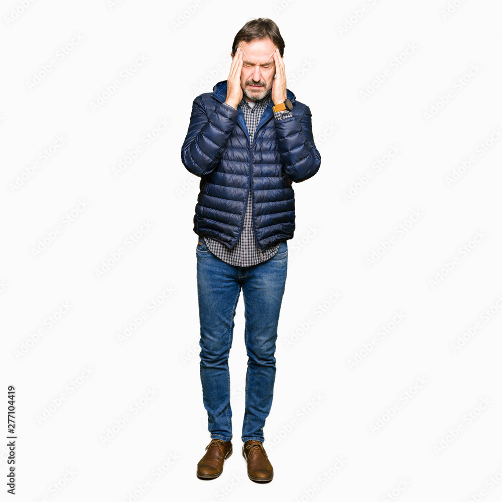 Middle age handsome man wearing winter coat with hand on head for pain in head because stress. Suffering migraine. Middle age handsome man wearing winter coat with hand on head for pain in head because stress. Suffering migraine.