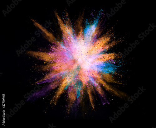 Explosion of colored powder on black background