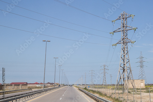Electricity pylon on nature background . Electricity transmission power lines High voltage tower . Power line high voltage post with blue sky background. © Adil