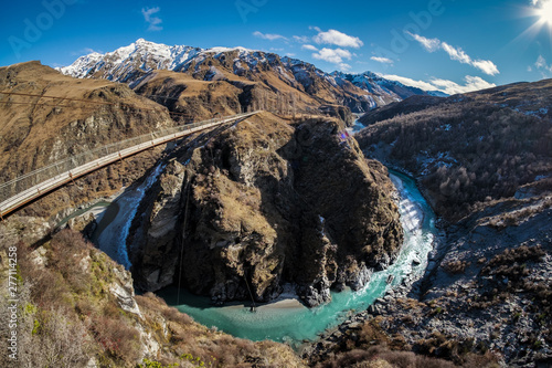 Located in New Zealand's South Island, the Skippers Canyon Road is known for its scenic roads, and scary narrow road. There are steep sheer cliff face. Below is the famous shotover river stream. photo