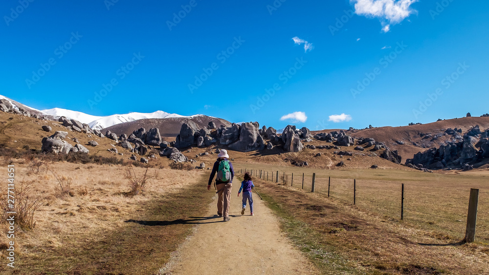 Scenic View around Castle Hill with Castle Hill Peak in the Background Locate in South Island of New Zealand. Mother and child hiking natural landscape.