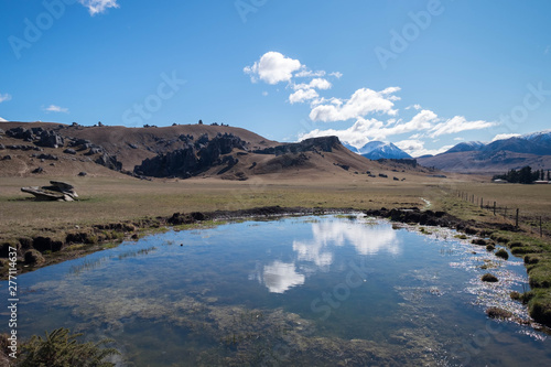Landscape image of blue sky, mountain and lake in New Zealand. Peaceful natural scenery background.