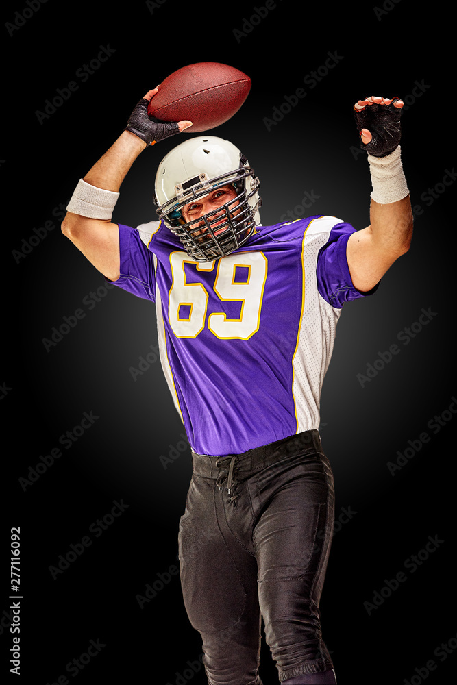 American football player in motion with the ball on a black background with a light line, copy space. The concept of the game is American football, movement. American football player in motion with the ball on a black background with a light line, copy space. The concept of the game is American football, movement.