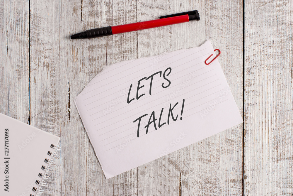 Word writing text Let S Is Talk. Business photo showcasing suggesting in the beginning of a conversation on the topic Torn paper and notebook sheet with a pen placed on top of wooden table