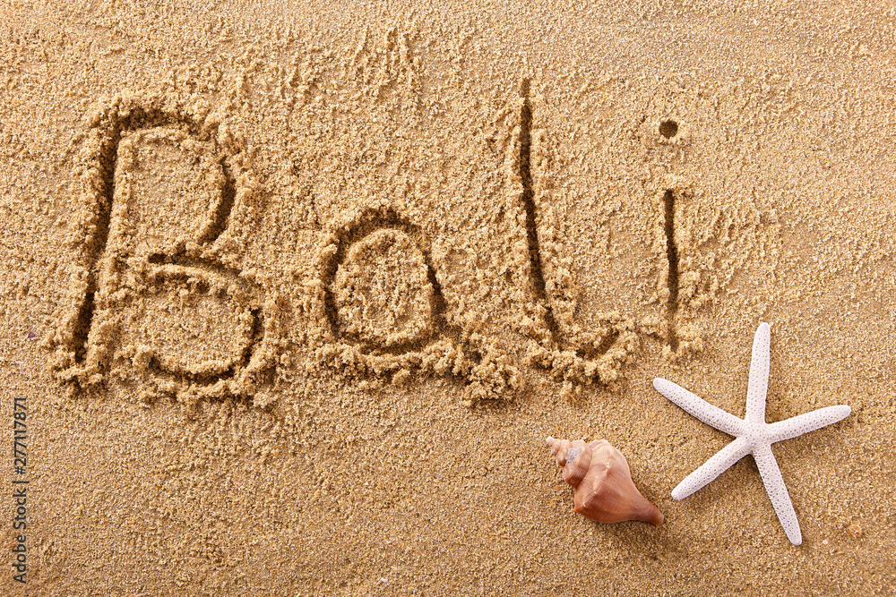 Bali word written in sand sign writing drawing drawn on a sunny summer beach with starfish holiday vacation travel destination message photo Bali word written in sand sign writing drawing drawn on a sunny summer beach with starfish holiday vacation travel destination message photo