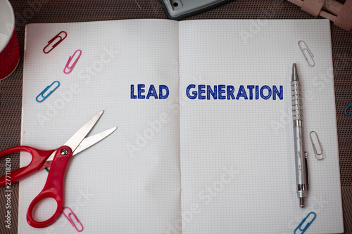 Conceptual hand writing showing Lead Generation. Concept meaning initiation of consumer interest or enquiry into products Scissors and equipments math book above textured backdrop photo