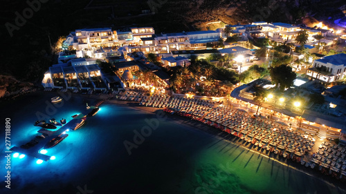 Aerial drone night shot of famous Psarou beach with luxury resorts and yachts docked, Mykonos island, Cyclades, Greece photo