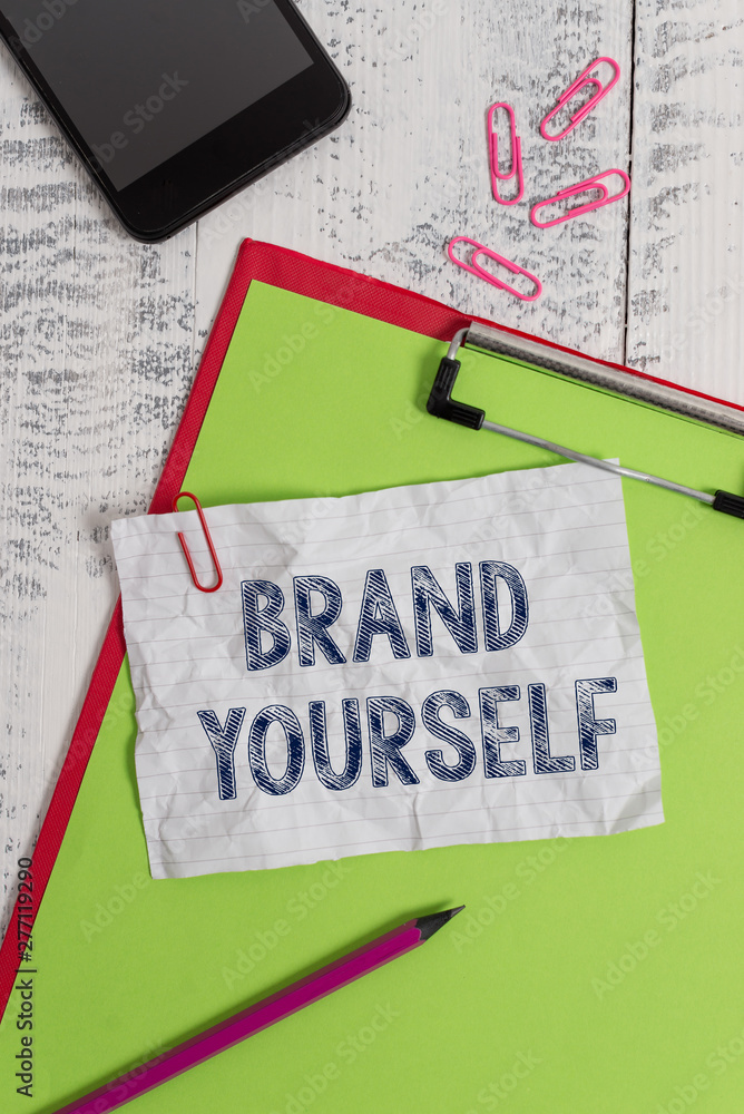 Handwriting text Brand Yourself. Conceptual photo Develop a unique professional identity Personal product Clipboard paper sheet pencil smartphone note clips wooden retro background Handwriting text Brand Yourself. Conceptual photo Develop a unique professional identity Personal product Clipboard paper sheet pencil smartphone note clips wooden retro background