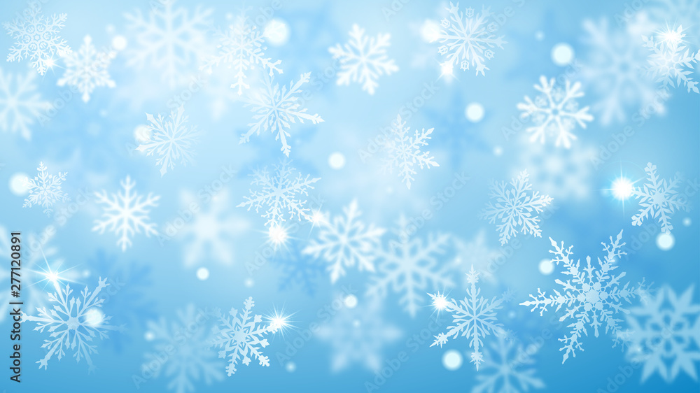 Christmas blurred background of complex defocused big and small falling snowflakes in light blue colors with bokeh effect