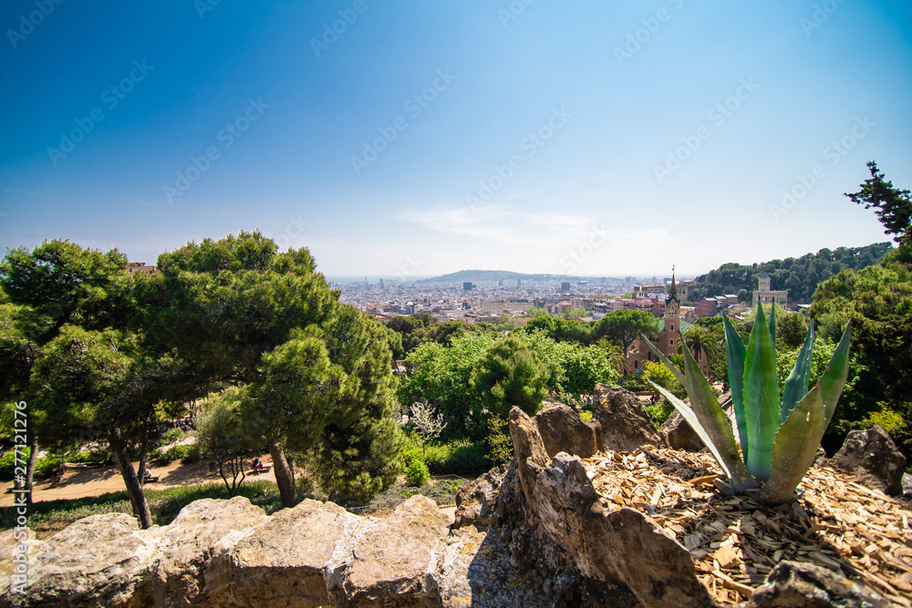 BARCELONA, SPAIN - April, 2019: Park Guell entrance buildings. The Park Guell is a public park system composed of gardens and architectonic elements. The park was designed by Antoni Gaudi. BARCELONA, SPAIN - April, 2019: Park Guell entrance buildings. The Park Guell is a public park system composed of gardens and architectonic elements. The park was designed by Antoni Gaudi.