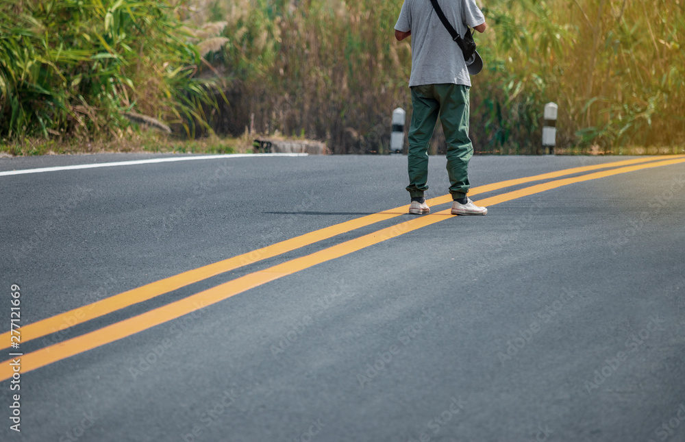 Men wearing sneakers walking on the streets with yellow lines. Men wearing sneakers walking on the streets with yellow lines.