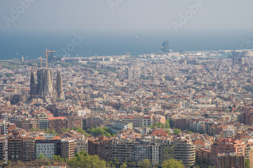 Barcelona, Spain - April, 2019: View of Barcelona city and costline in spring from the Bunkers in Carmel neighborhood. Few building stand out like sagrada familia and Agbar tower